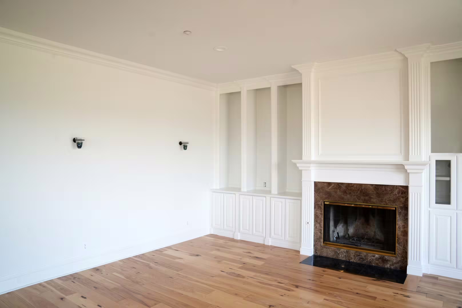 White built-in cabinetry and fireplace after interior painting