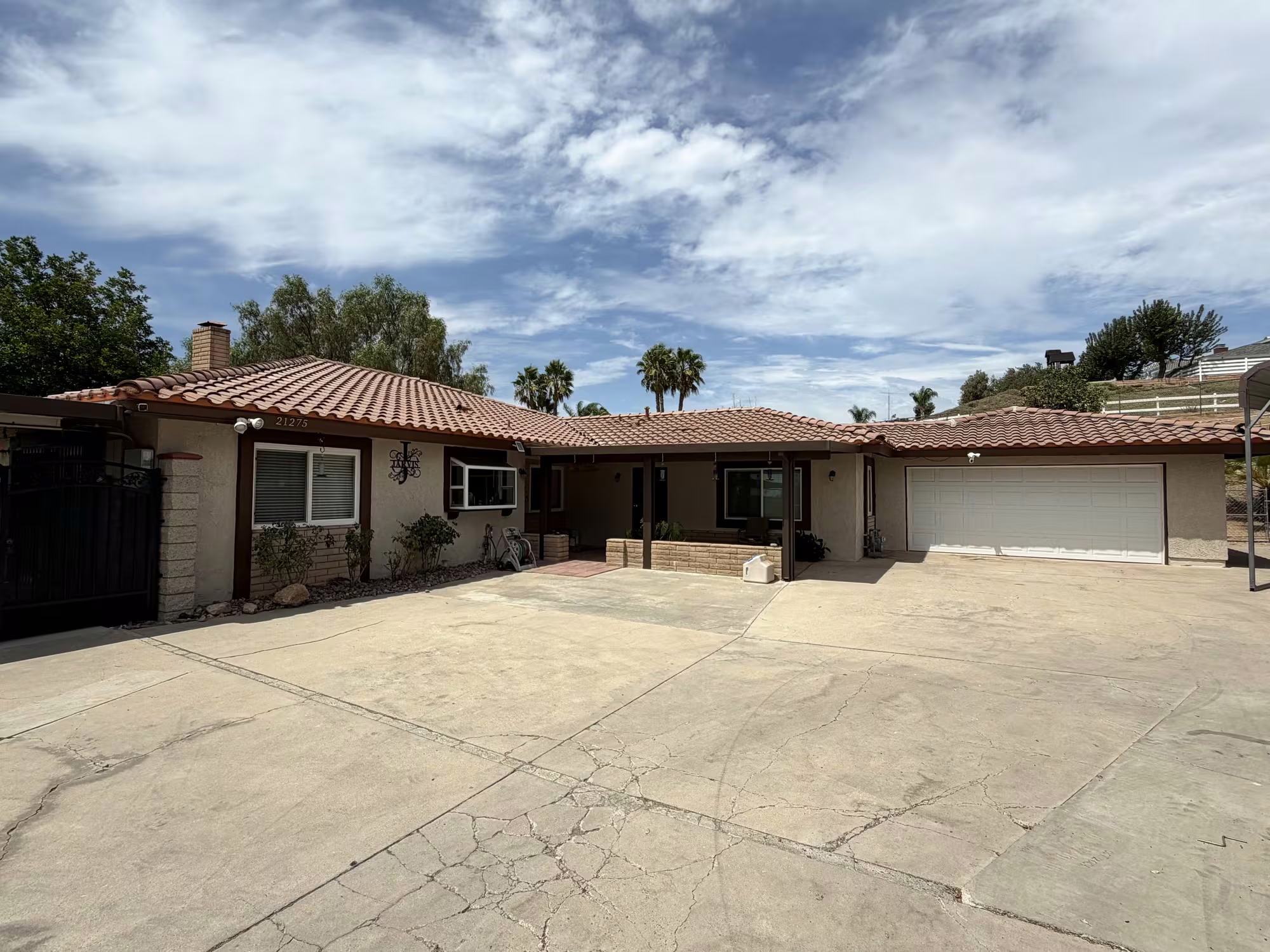 Wide view of house exterior with driveway after exterior painting